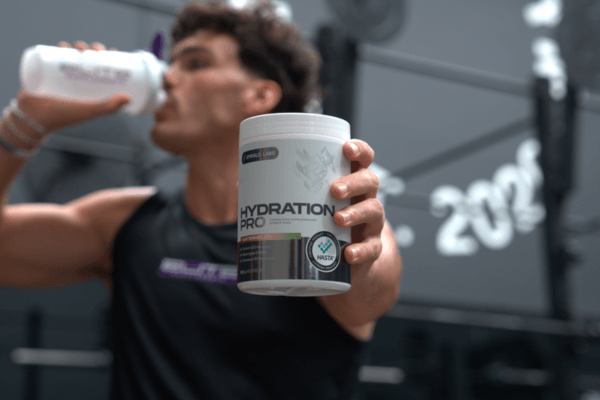 Athlete holding Emrald Labs Hydration Pro supplement