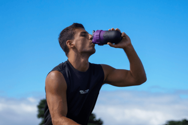 Athlete drinking electrolytes from a shaker