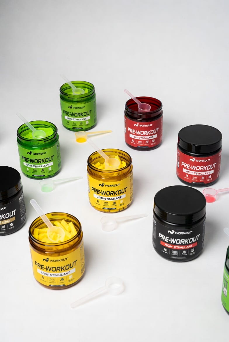 A lineup of pre-workout tubs in non-stimulant, low-stimulant and high-stimulant labelled variants with scoops